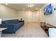 Modern living area with plush sofa, TV, side table, and neutral decor at 1292 Blue Island Dr, Clermont, FL 34714