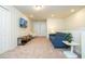 Comfortable living room with a blue sofa, accent chair, TV, and stylish side tables at 1292 Blue Island Dr, Clermont, FL 34714