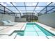 Private screened-in pool with lounge chairs for relaxing poolside at 1292 Blue Island Dr, Clermont, FL 34714