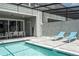 Inviting pool area with patio, dining set, and comfortable lounge chairs at 1292 Blue Island Dr, Clermont, FL 34714