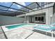 Relaxing screened-in pool area with lounge chairs and a brick patio, perfect for enjoying sunny days at 1292 Blue Island Dr, Clermont, FL 34714