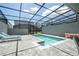 Private screened-in pool area with brick-paved patio and cozy seating for outdoor relaxation at 1292 Blue Island Dr, Clermont, FL 34714