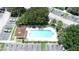 Aerial view of community pool, parking and lush trees at 13207 Villa Vista Dr # 205, Orlando, FL 32824