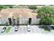 Overview of the condo complex and available parking spaces with trees at 13207 Villa Vista Dr # 205, Orlando, FL 32824