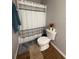Clean bathroom with neutral walls, new toilet, and updated floors at 13207 Villa Vista Dr # 205, Orlando, FL 32824