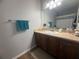 Well-lit bathroom with stylish vanity, sink, and neutral color scheme for a calming atmosphere at 13207 Villa Vista Dr # 205, Orlando, FL 32824