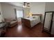 Charming bedroom with hardwood floors, ceiling fan, and cozy chair, offering a relaxing retreat at 13207 Villa Vista Dr # 205, Orlando, FL 32824