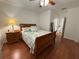 Cozy bedroom with hardwood floors, featuring a comfortable bed and relaxing ambiance at 13207 Villa Vista Dr # 205, Orlando, FL 32824