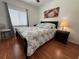 Inviting bedroom with hardwood floors, ceiling fan, and ample natural light for a relaxing experience at 13207 Villa Vista Dr # 205, Orlando, FL 32824
