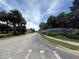 Villa Del Sol community entrance with signage and lush landscaping at 13207 Villa Vista Dr # 205, Orlando, FL 32824