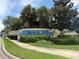 Villa Del Sol community sign with landscaping and palm trees at 13207 Villa Vista Dr # 205, Orlando, FL 32824
