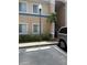 Exterior of condo building featuring well-manicured landscaping and parking at 13207 Villa Vista Dr # 205, Orlando, FL 32824