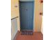 Blue front door with a stylish knocker and a welcome mat to enter the home at 13207 Villa Vista Dr # 205, Orlando, FL 32824