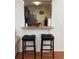 Open kitchen view with bar seating and stylish granite countertops at 13207 Villa Vista Dr # 205, Orlando, FL 32824