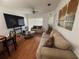 Cozy living room with comfortable couches, ceiling fan, and a view of the dining area at 13207 Villa Vista Dr # 205, Orlando, FL 32824
