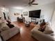 Comfortable living room featuring stylish decor, and hard floors, perfect for entertaining and relaxation at 13207 Villa Vista Dr # 205, Orlando, FL 32824