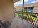 Screened patio with tile floor overlooks garden in complex at 13207 Villa Vista Dr # 205, Orlando, FL 32824