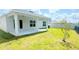 A well-manicured backyard with a covered patio at 1557 Venice Ln, Davenport, FL 33896