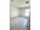 A bright bedroom with a window, tiled floors, and neutral wall paint at 1557 Venice Ln, Davenport, FL 33896