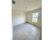 This bedroom has tiled floors, a window, and blank walls at 1557 Venice Ln, Davenport, FL 33896