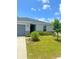 A well-maintained single-story home with a green lawn and manicured landscaping at 1557 Venice Ln, Davenport, FL 33896