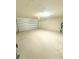 Spacious two-car garage with a white door and room for parking and storage at 1557 Venice Ln, Davenport, FL 33896
