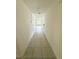 Hallway with tiled floor leading to a room with a window at 1557 Venice Ln, Davenport, FL 33896