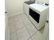 Well-lit laundry area with modern, side-by-side washer and dryer units at 1557 Venice Ln, Davenport, FL 33896