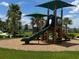 Playground with green slide, mulch, and green grass at 1557 Venice Ln, Davenport, FL 33896