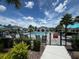 Community pool area with lounge chairs and a cabana in the background at 1557 Venice Ln, Davenport, FL 33896