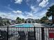 Community pool area with lounge chairs, palm trees, and a cabana at 1557 Venice Ln, Davenport, FL 33896
