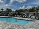 Community pool featuring ample seating, clear water, and a welcoming atmosphere for relaxation and recreation at 1557 Venice Ln, Davenport, FL 33896