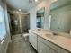 Bathroom features double sinks, a glass-enclosed shower, and large mirrors above the vanities at 15579 Water Spring Blvd, Winter Garden, FL 34787