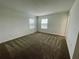 This bedroom features neutral walls and flooring, plus bright windows for natural light at 15579 Water Spring Blvd, Winter Garden, FL 34787
