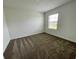 This bedroom features neutral walls and flooring, plus a bright window for natural light at 15579 Water Spring Blvd, Winter Garden, FL 34787