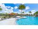 Inviting community pool with comfortable lounge chairs and vibrant tropical landscaping at 15579 Water Spring Blvd, Winter Garden, FL 34787