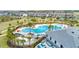 Aerial view of a community pool complex featuring multiple pools and recreational areas at 15579 Water Spring Blvd, Winter Garden, FL 34787