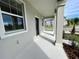 View of the covered porch with painted concrete columns at 15579 Water Spring Blvd, Winter Garden, FL 34787