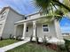 Beautiful home exterior showcasing a manicured lawn and column-lined entryway at 15579 Water Spring Blvd, Winter Garden, FL 34787