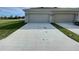 Spacious three-car garage with ample parking and a well-maintained driveway at 15579 Water Spring Blvd, Winter Garden, FL 34787