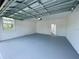 Interior view of a clean and spacious garage with painted walls and floors at 15579 Water Spring Blvd, Winter Garden, FL 34787