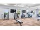 Spacious gym featuring state-of-the-art exercise equipment and multiple TVs for entertainment at 15579 Water Spring Blvd, Winter Garden, FL 34787