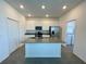 Modern kitchen with stainless steel appliances, center island, and bright lighting at 15579 Water Spring Blvd, Winter Garden, FL 34787