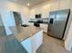 Bright kitchen featuring stainless steel appliances and center island at 15579 Water Spring Blvd, Winter Garden, FL 34787