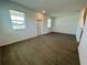 Bright, open living room featuring tile floors, a white door and large windows with modern blinds at 15579 Water Spring Blvd, Winter Garden, FL 34787