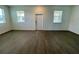 This open living room has a modern entry door, two windows with modern blinds, and tiled floors at 15579 Water Spring Blvd, Winter Garden, FL 34787