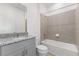 Bathroom with granite countertop, a shower-over-tub combination with tiled walls, and ample lighting at 1580 Gardiner St, Haines City, FL 33844