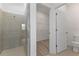 Bright bathroom featuring a glass-enclosed shower and a toilet at 1580 Gardiner St, Haines City, FL 33844