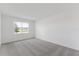 Bright, carpeted bedroom featuring a large window with peaceful outdoor views at 1580 Gardiner St, Haines City, FL 33844