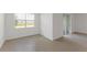 Well-lit bedroom with tile flooring, offering a serene and minimalist aesthetic at 1580 Gardiner St, Haines City, FL 33844